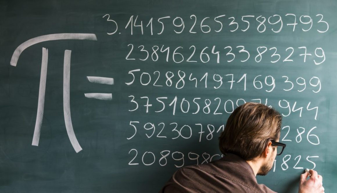A person writing down the numerical value of pi on a blackboard